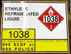 ISO tank truck hazmat label for Ethylene Refrigerated Liquid (UN No. 1038), showing a red flammable gas diamond placard with Class 2 designation. Emergency contact: dial 999 SCDF or 999 Police.
